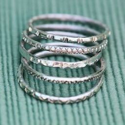 silver stacking rings with stamped designs and patterns