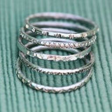 silver stacking rings with stamped designs and patterns